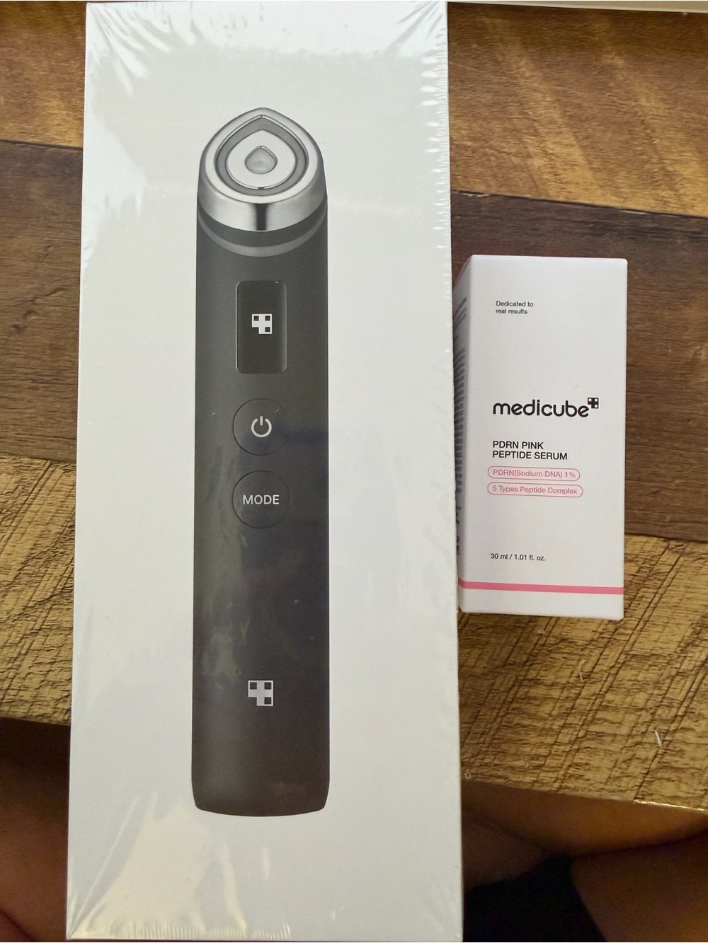 Medicube Black Facial Skincare Device with Pink Peptide Serum